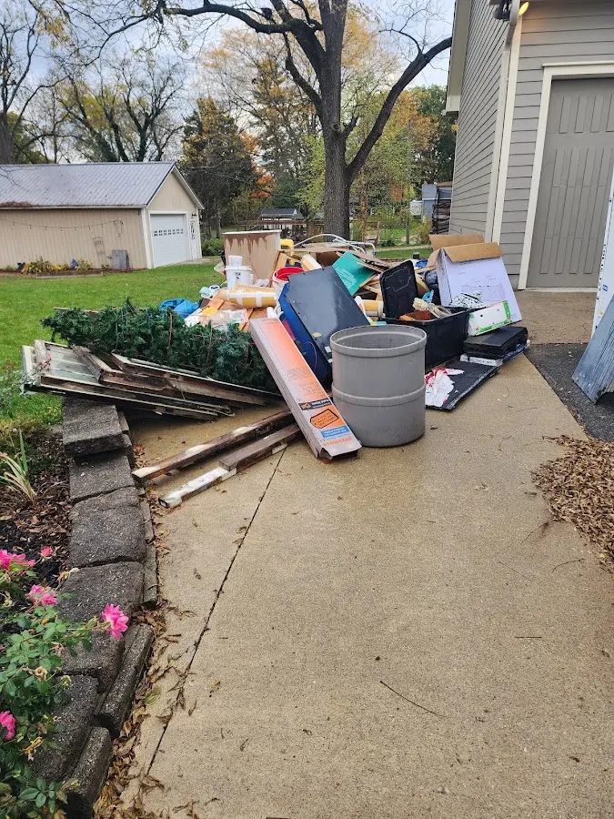 Dumpster being loaded with debris for Estate Cleanout Dumpster Rental in Bainbridge
